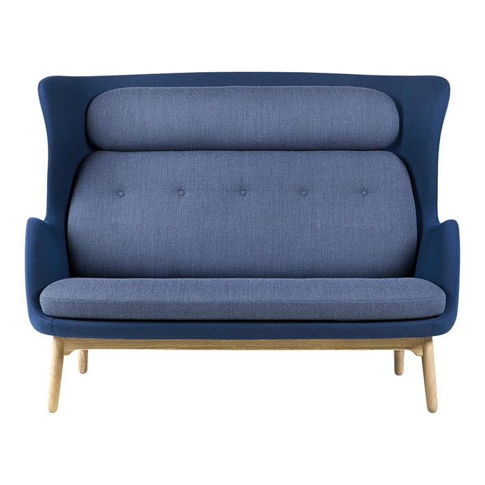 Blue and grey upholstered sofa with a structured pattern and wooden legs, featuring a modern curved design.