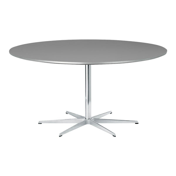 Round grey tabletop with a sleek chrome base, featuring a minimalist design and smooth surface.