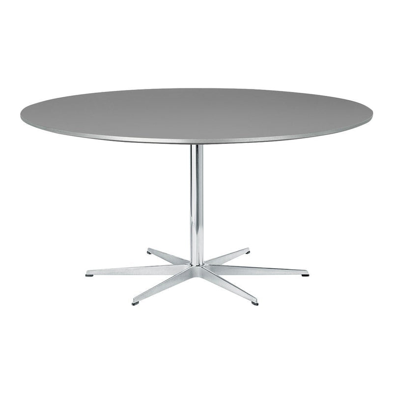 Round grey tabletop with a sleek chrome base, featuring a minimalist design and smooth surface.