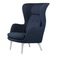 Navy blue upholstered high-back armchair with sleek silver legs and subtle tufted details. Stylish and modern design.