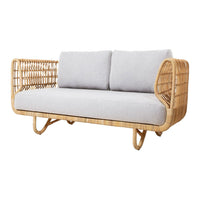 Light grey cushions on a natural rattan frame, featuring an open weave and contemporary design. Ideal for modern decor.