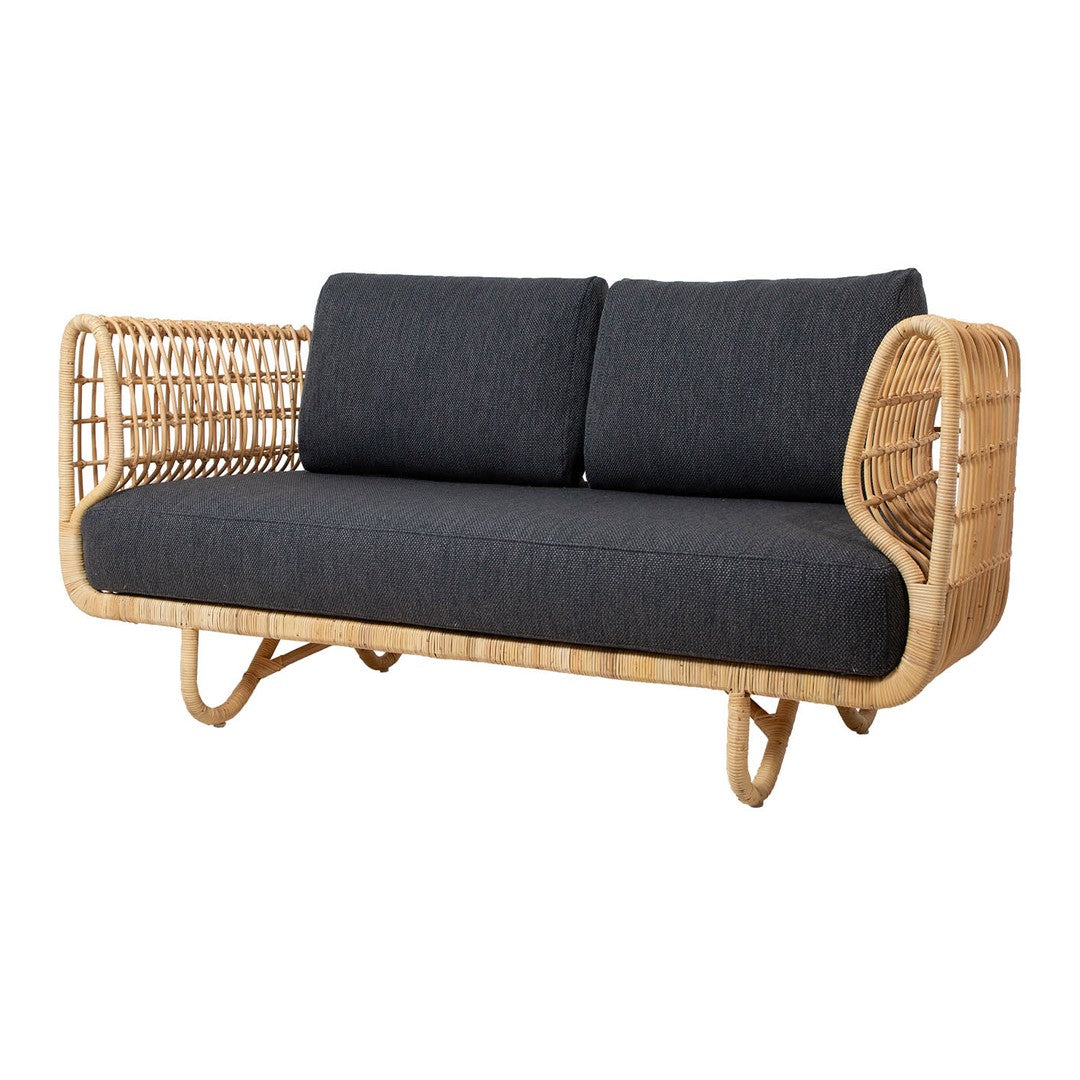 Rattan loveseat with a natural woven frame and dark gray upholstery, featuring a modern, minimalist design.