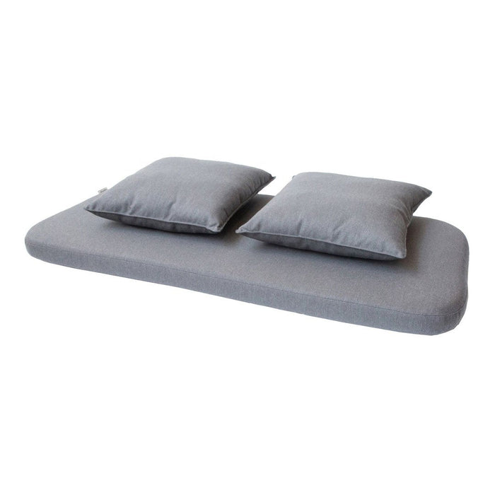 Gray mattress with two matching decorative pillows, featuring a smooth texture and minimalist design.