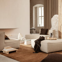 Beige and brown living room with minimalist furniture, soft textures, and a cozy atmosphere. Neutral tones and layered patterns.