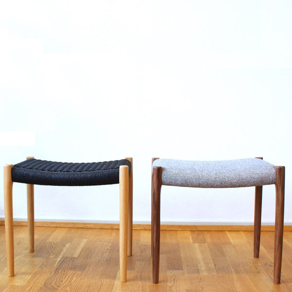 Black and gray patterned stools with light and dark wood legs against a minimalist background.