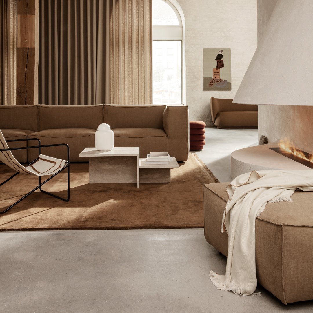 Neutral beige tones with soft textures and patterns in a contemporary living room setting. Warm and inviting design.