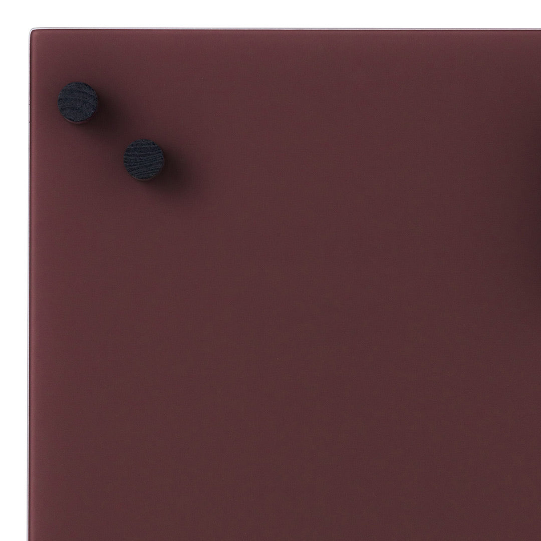 Deep burgundy surface with matte finish, accented by two black circular knobs.