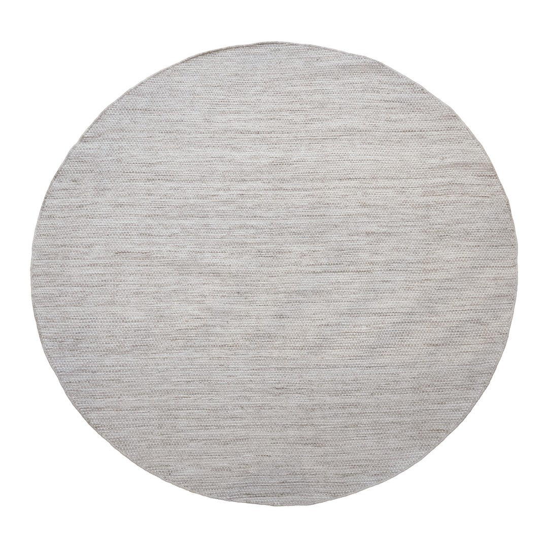 Round area rug in a soft gray hue with a subtle textured pattern, ideal for modern decor.