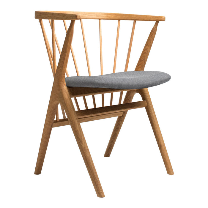 Light oak chair with a modern spindle back, featuring a soft gray upholstered seat. Simple, elegant design.