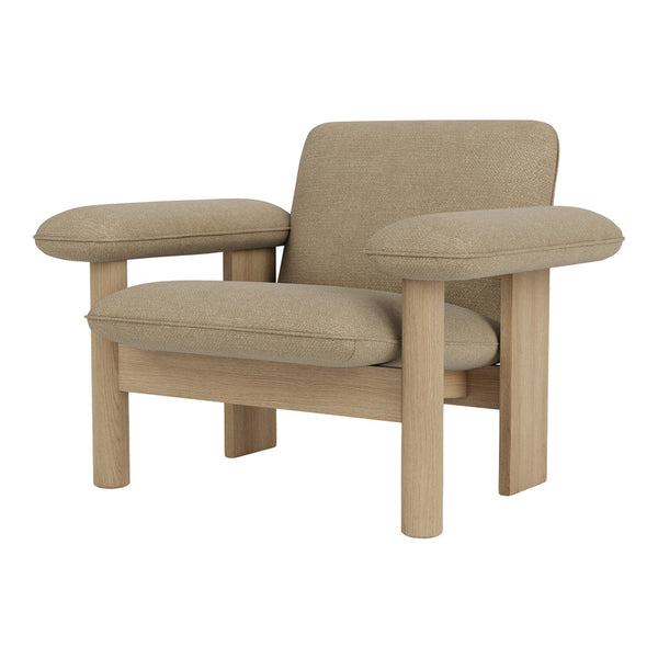 Beige upholstered chair with soft cushions and natural wood legs, showcasing a minimalist design and neutral color palette.
