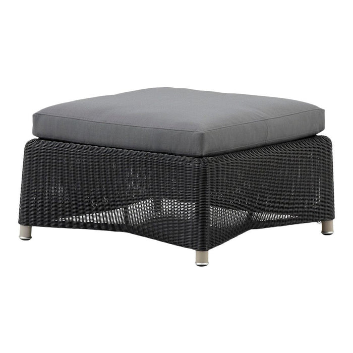 Black woven outdoor ottoman with a gray cushioned top, featuring a modern, textured design. Perfect for stylish relaxation.