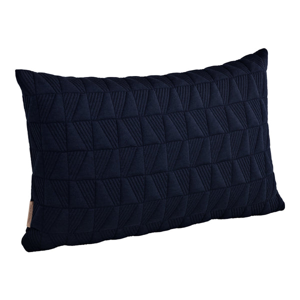 Navy blue textured pillow with a geometric pattern of raised triangles. Perfect for modern decor.