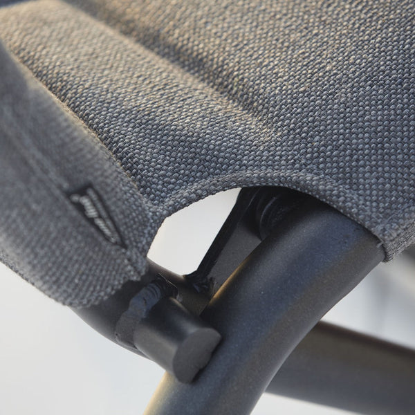 Close-up of a textured gray fabric with subtle patterns, highlighting the black metal frame and stitching details.