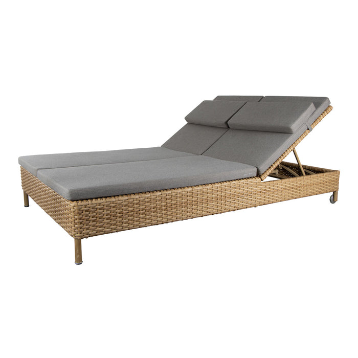 Gray cushioned lounge chair with a woven rattan base, featuring a modern and sleek design perfect for outdoor relaxation.
