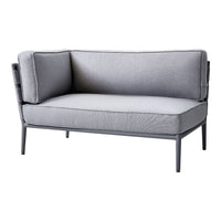 Gray upholstered loveseat with clean lines and subtle texture. Features a modern design and sleek metal frame.