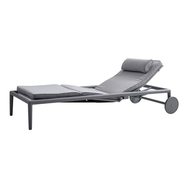 Gray lounge chair with a sleek, modern design and textured upholstery, featuring a comfortable headrest and minimalist frame.