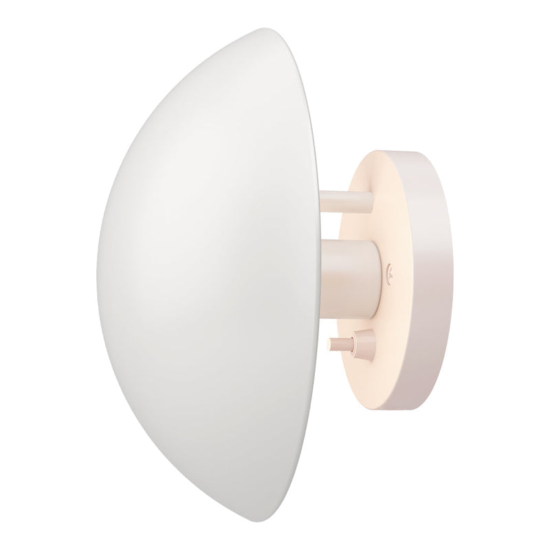 Sleek white wall sconce with a soft pink mount, featuring a modern half-dome design for a contemporary aesthetic.