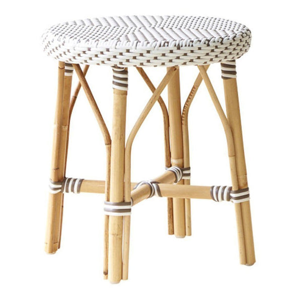 White woven pattern with geometric design on a natural bamboo stool, accented by thin brown stripes.