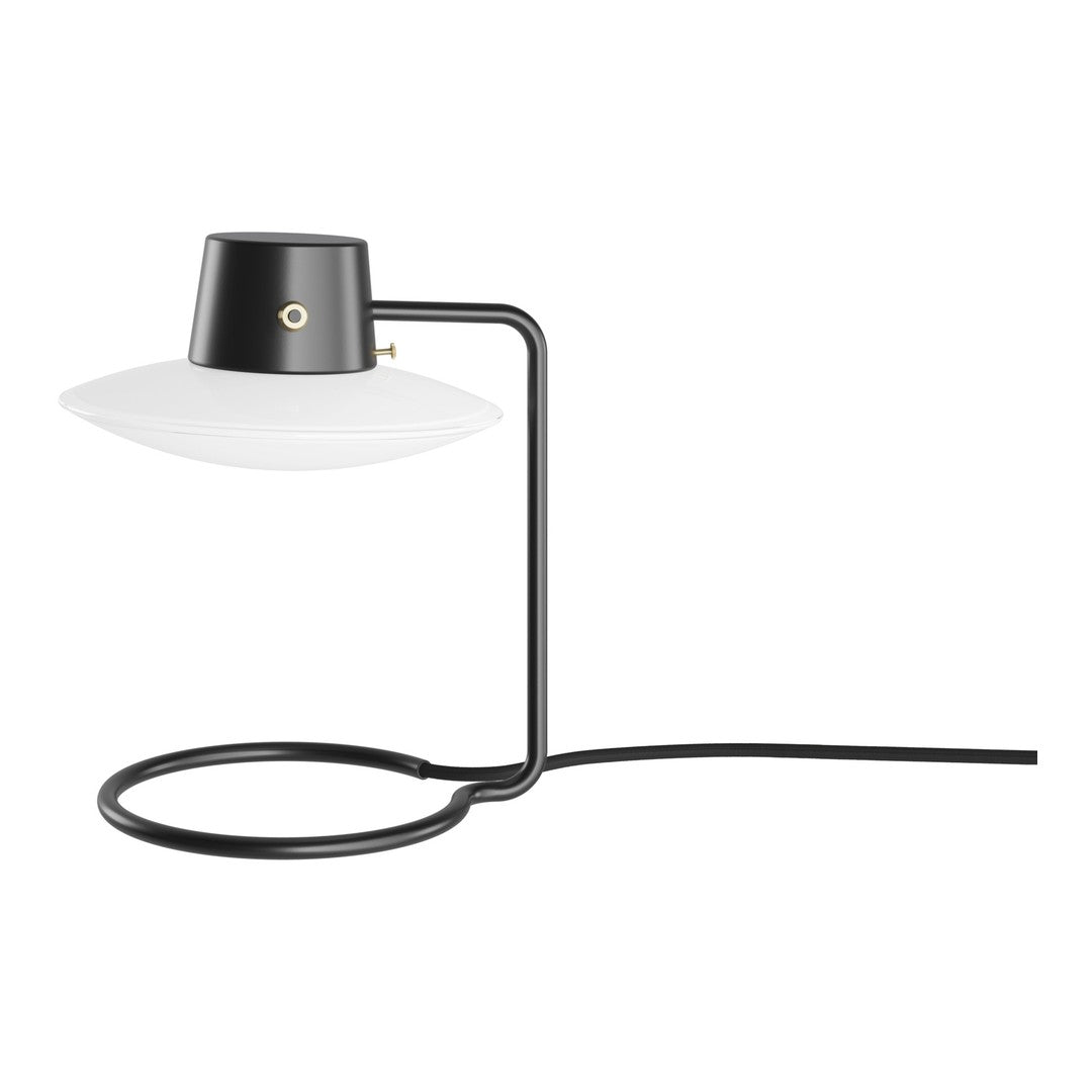 Modern black and white table lamp with a sleek, minimalist design and circular base. Ideal for contemporary decor.
