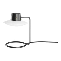 Modern black and white table lamp with a sleek, minimalist design and circular base. Ideal for contemporary decor.