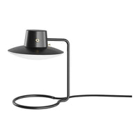 Modern black and white table lamp with sleek design and circular base, perfect for contemporary decor.