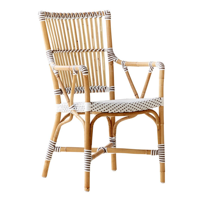 "Natural rattan chair with white and black striped accents, featuring a classic woven pattern."