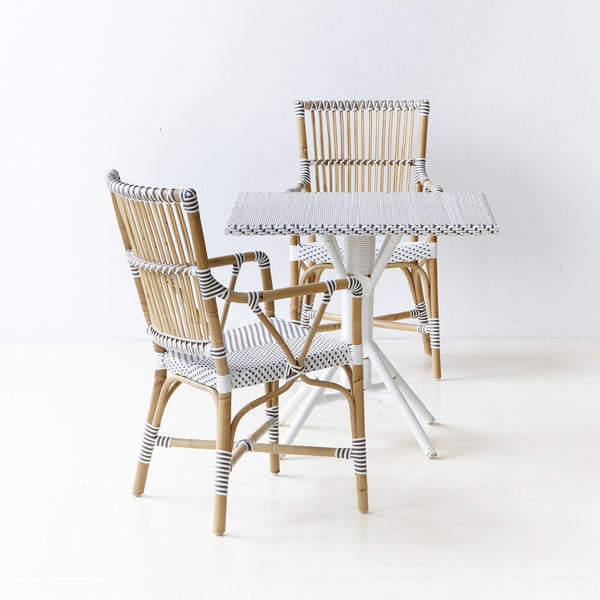 Bistro table and chairs featuring natural wood tones with white and black striped patterns. Perfect for outdoor settings.
