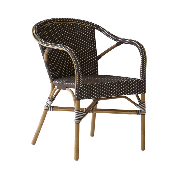 Brown woven chair with white polka dots, featuring a natural bamboo frame and stylish curved design.