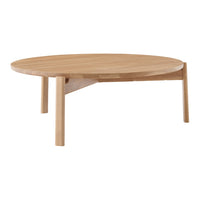 Natural wood round coffee table with a light oak finish and smooth surface. Simple, minimalist design with no patterns.