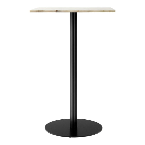 Modern table with a sleek black base and a textured light-colored top. Ideal for contemporary decor.