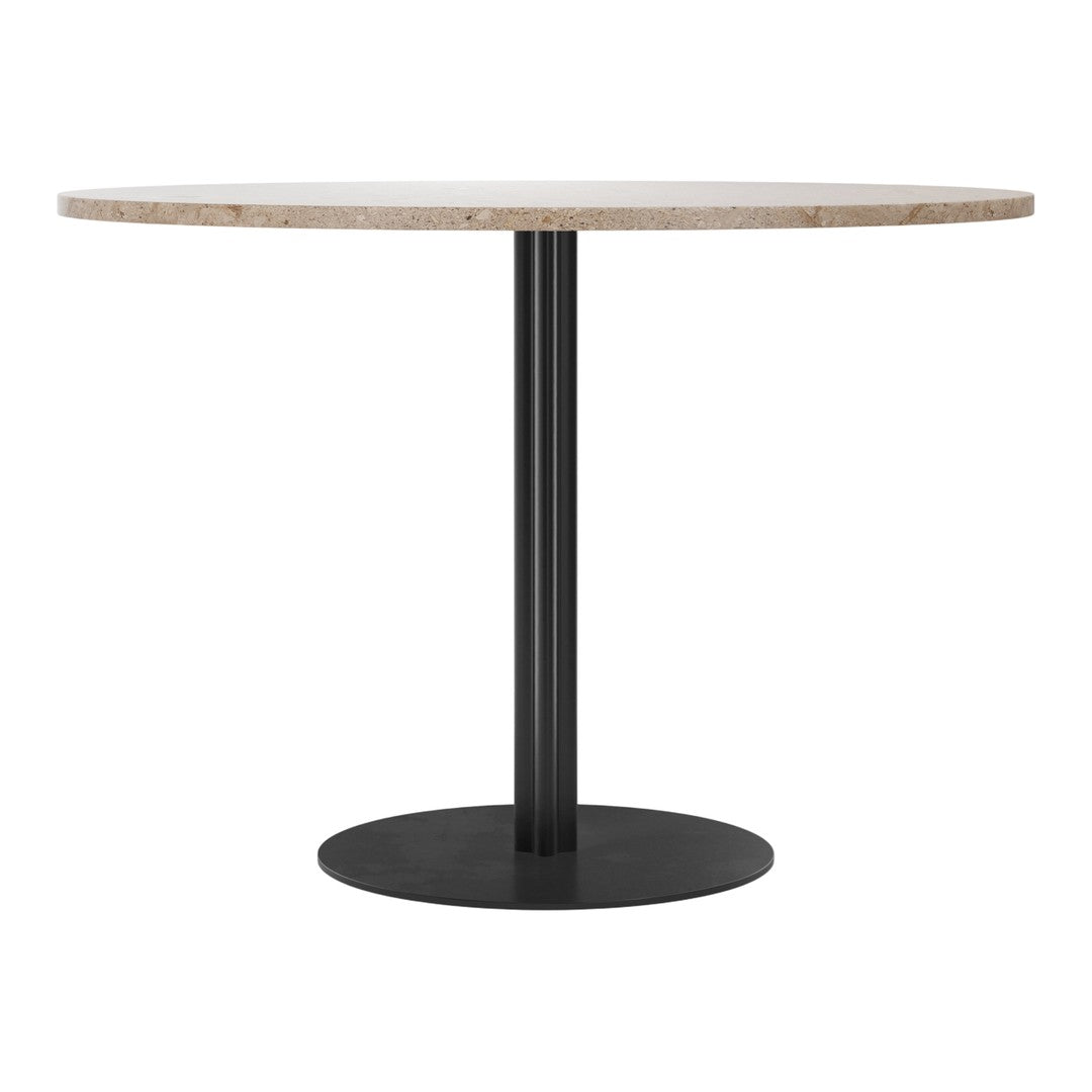 Round table with a natural stone top and a sleek black metal base, showcasing a minimalistic and modern design.