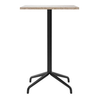 Modern black metal table with a light granite top, featuring a sleek, minimalistic design. Perfect for contemporary spaces.
