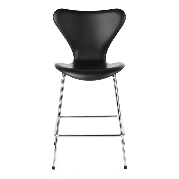 Black molded chair with smooth curves and shiny chrome legs, showcasing a modern, minimalist design.