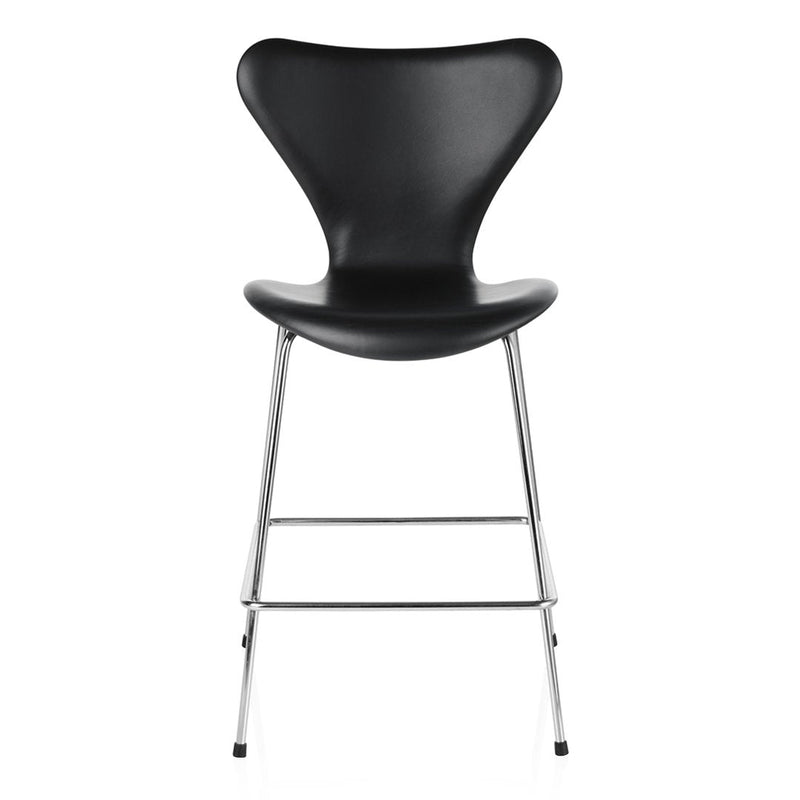 Black molded chair with smooth curves and shiny chrome legs, showcasing a modern, minimalist design.