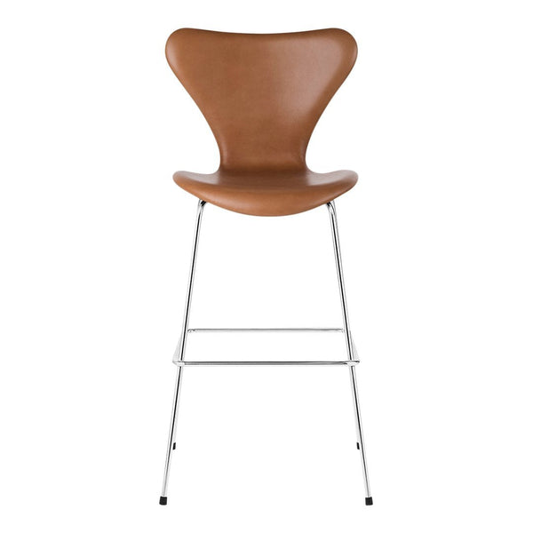 Brown leather bar stool with an ergonomic curved design and sleek chrome legs. Ideal for modern decor.