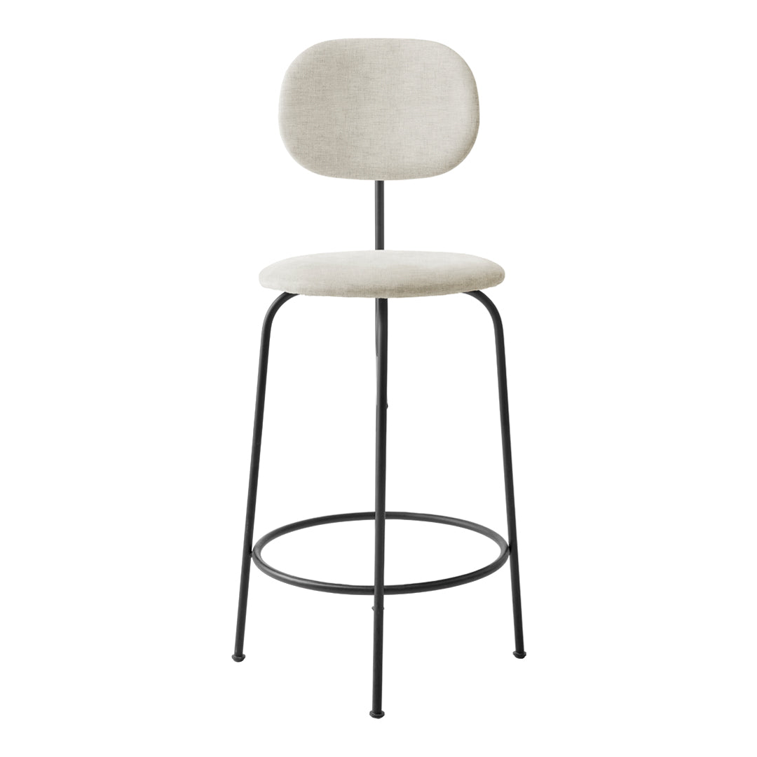 Neutral beige upholstered bar stool with a minimalist design and black metal legs. Simple, modern aesthetic.