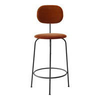 Rust-orange velvet bar stool with a sleek black metal frame and minimalist design. Perfect for modern decor.