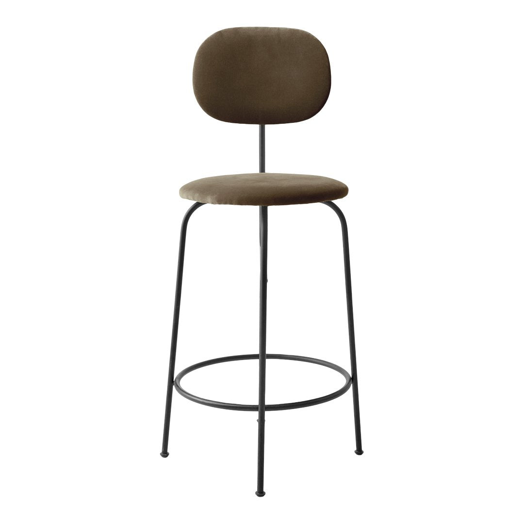 Stylish brown upholstered bar stool with a minimalist black metal frame and a smooth, rounded design.