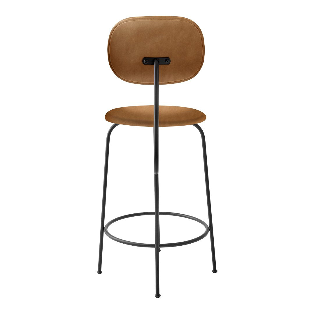 Tan upholstered bar stool with a minimalistic black metal frame and smooth, curved seat design.
