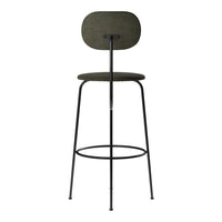 Green fabric bar stool with a smooth, rounded backrest and sleek black metal legs. Minimalist design and contemporary style.