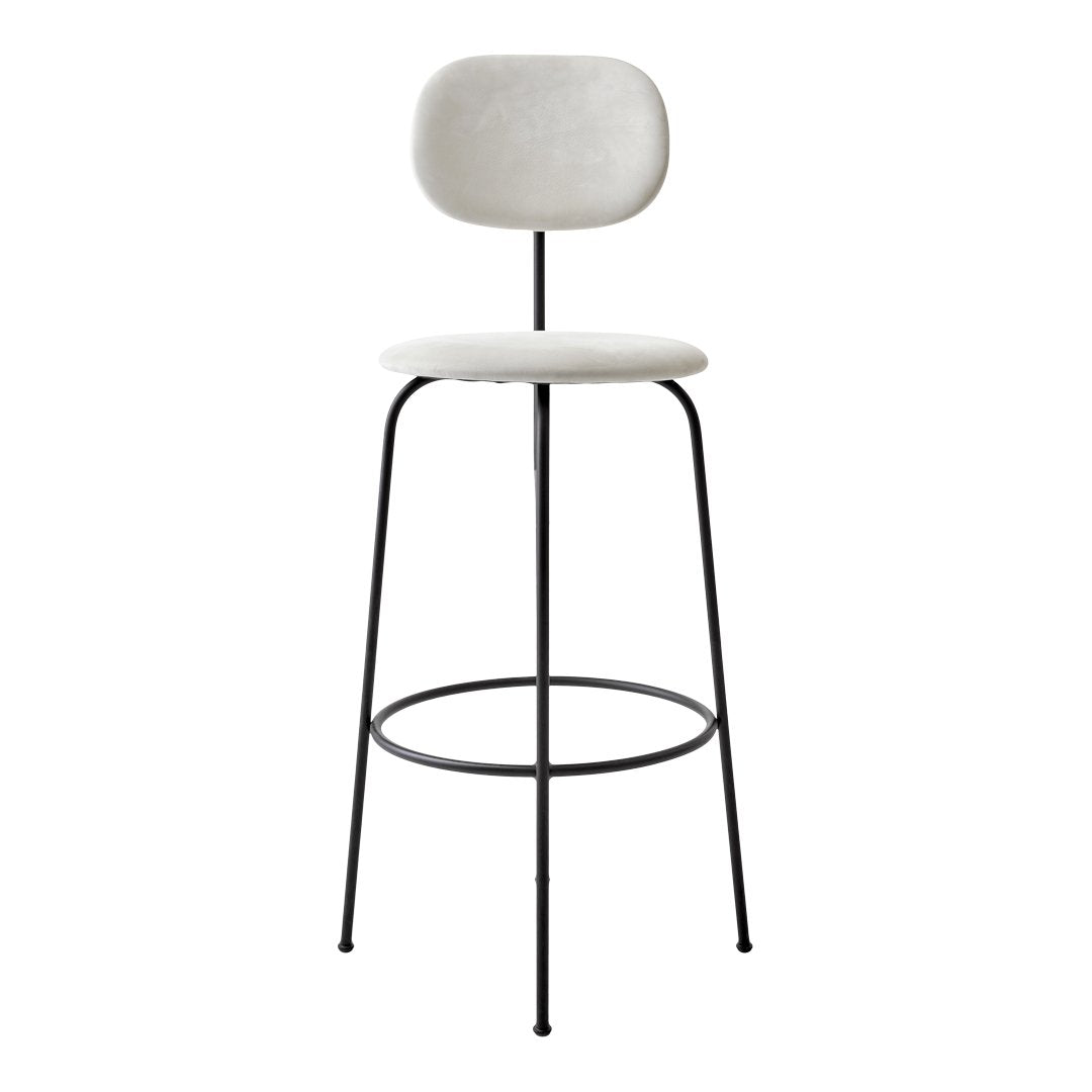 Neutral white seat with a smooth finish, paired with sleek black metal legs for a modern contrast.