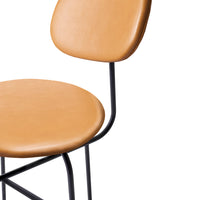 Tan leather chair seat with a sleek black metal frame and minimalistic design. Ideal for modern decor.