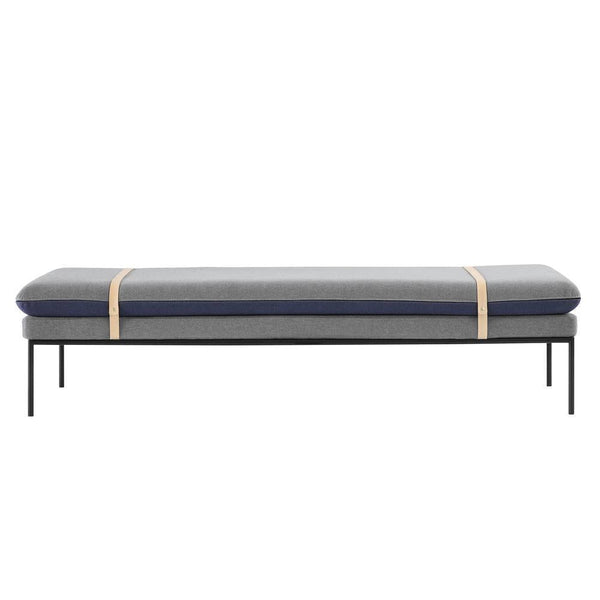 Gray and navy patterned cushion on a sleek black metal frame, enhanced with stylish beige straps.