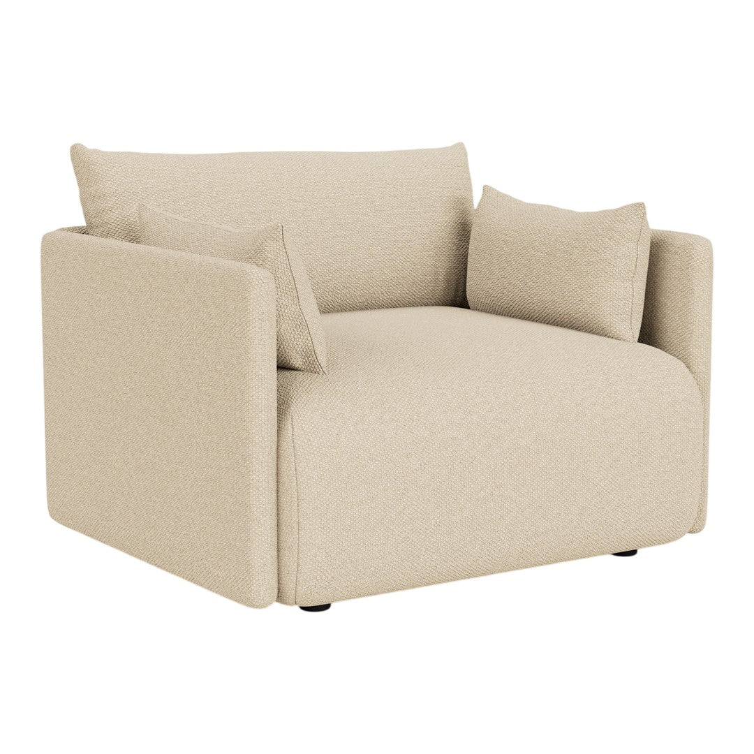 Beige armchair with a modern, minimalist design and soft, textured fabric, featuring two decorative cushions.