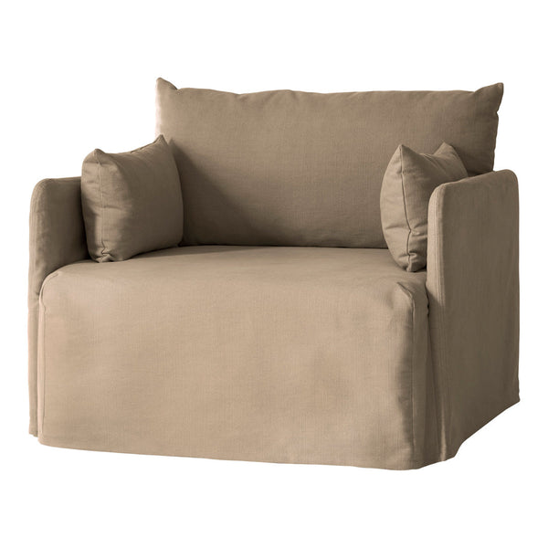 Beige fabric chair with soft texture and simple, contemporary design, featuring two matching throw pillows.