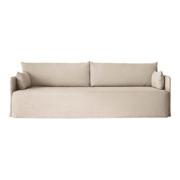 Beige, minimalist sofa with textured fabric and soft, inviting cushions, perfect for modern living spaces.