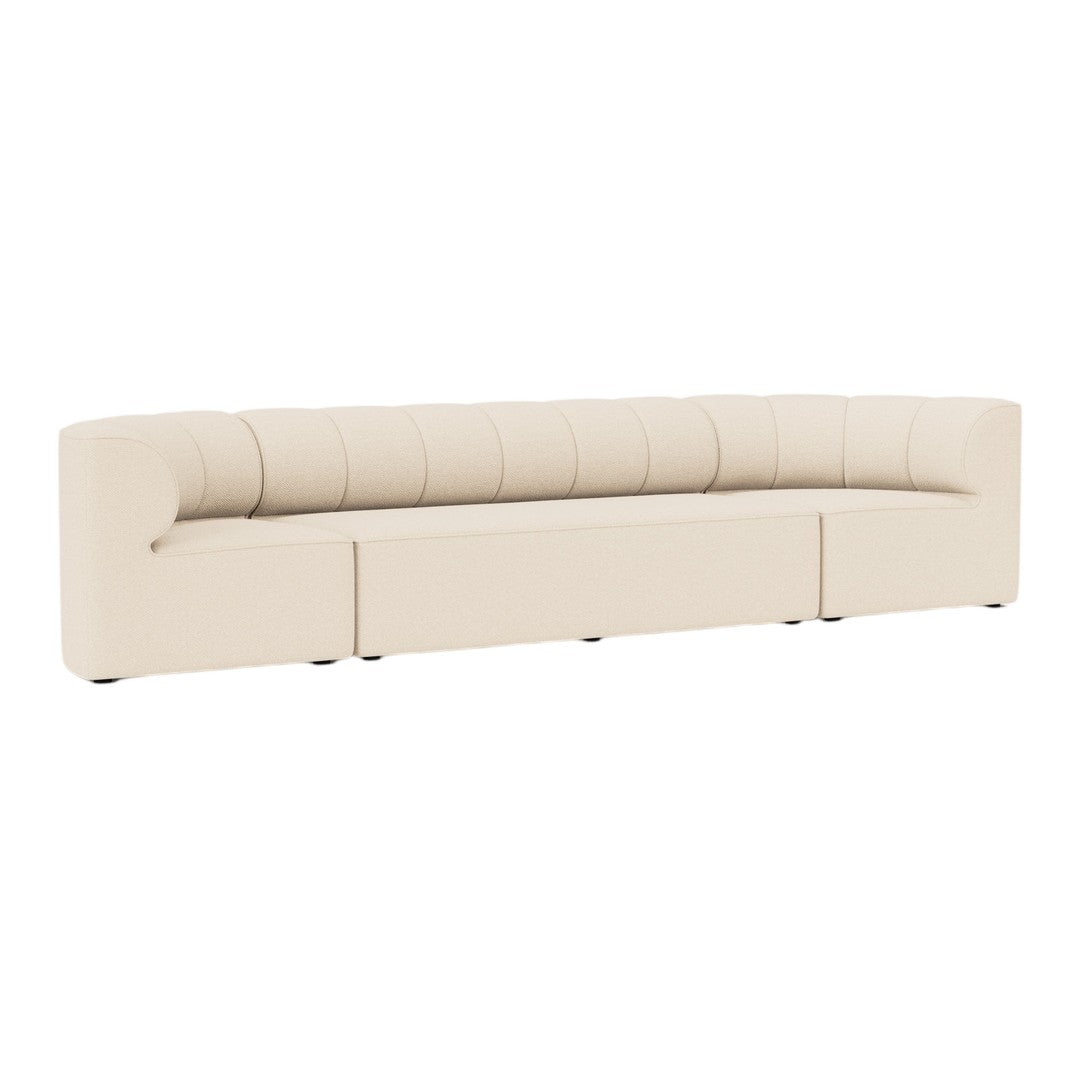 Beige curved sofa with quilted detailing, maintaining a modern minimalist design. Ideal for contemporary interiors.