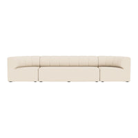 Beige curved sofa with tufted detailing, featuring a smooth, minimalist design for modern decor.