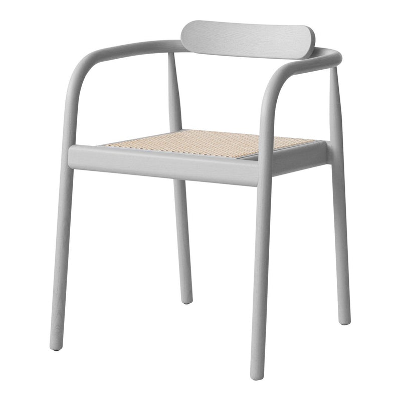 Light gray chair with a natural woven rattan seat, showcasing a minimalist design and modern aesthetic.