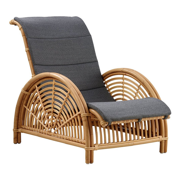 Gray cushioned rattan lounge chair with a curved bamboo frame and unique woven pattern design. Perfect for relaxation.